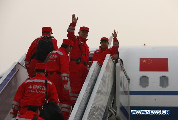 Members of the China's International Rescue Team board the plane at Beijing Capital International Airport in Beijing, capital of China, March 13, 2011. 