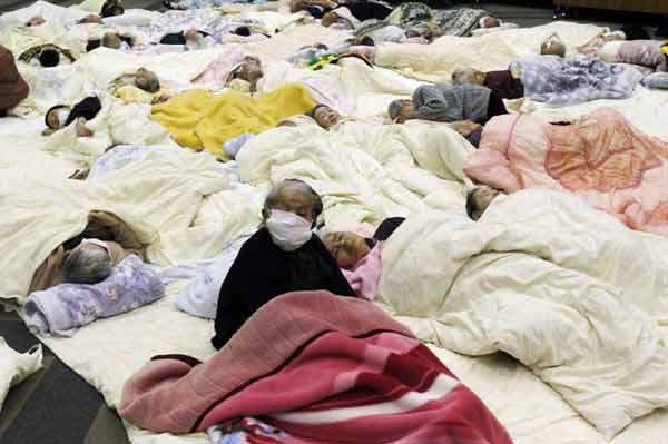 People who are evacuated from a nursing home which is located in evacuation area around the Fukushima Daini nuclear plant, rest at a temporary shelter in Koriyama, March 13, 2011. [Xinhua]