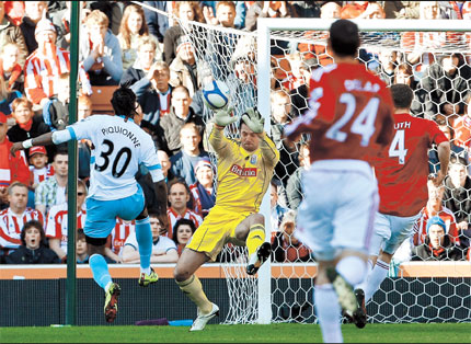 West Ham United's Frederic Piquionne (left) beats Stoke City goalkeeper Thomas Sorensen to score a goal during their English FA Cup quarterfinal at the Britannia Stadium, Stoke on Trent, yesterday. Stoke won 2-1.  