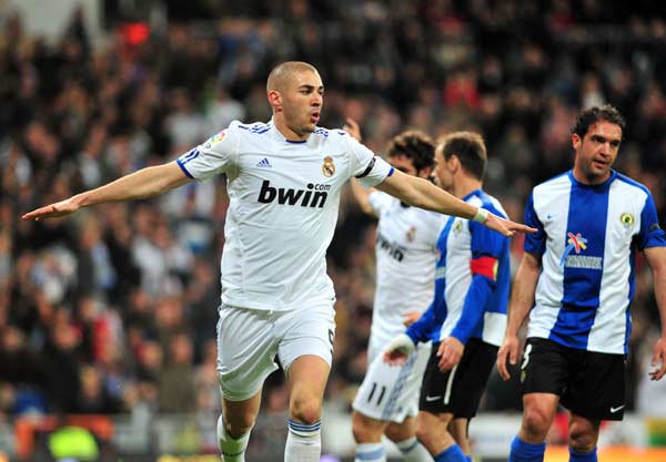 Karim Benzema (L) of Real Madrid celebrates for a goal during the Spanish league football match against Hercules in Madrid, capital of Spain, March 12, 2011. Real Madrid won 2-0. (Xinhua/Chen Haitong) 