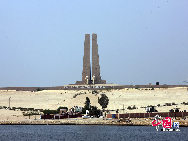 The Suez Canal, also known by the nickname 'The Highway to India', is an artificial sea-level waterway in Egypt, connecting the Mediterranean Sea and the Red Sea. Opened in November 1869 after 10 years of construction work, it allows water transportation between Europe and Asia without navigation around Africa. The northern terminus is Port Said and the southern terminus is Port Tawfik at the city of Suez. Ismailia lies on its west bank, 3 km (1.9 mi) north of the half-way point. [Photo by Chenzhu]