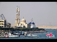 The Suez Canal, also known by the nickname 'The Highway to India', is an artificial sea-level waterway in Egypt, connecting the Mediterranean Sea and the Red Sea. Opened in November 1869 after 10 years of construction work, it allows water transportation between Europe and Asia without navigation around Africa. The northern terminus is Port Said and the southern terminus is Port Tawfik at the city of Suez. Ismailia lies on its west bank, 3 km (1.9 mi) north of the half-way point. [Photo by Chenzhu]
