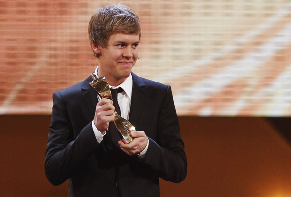 Formula One World Champion Sebastian Vettel holds his trophy for the German Athlete of the Year 2010 during a gala in Baden-Baden December 19, 2010.  (Xinhua/Reuters File Photo)