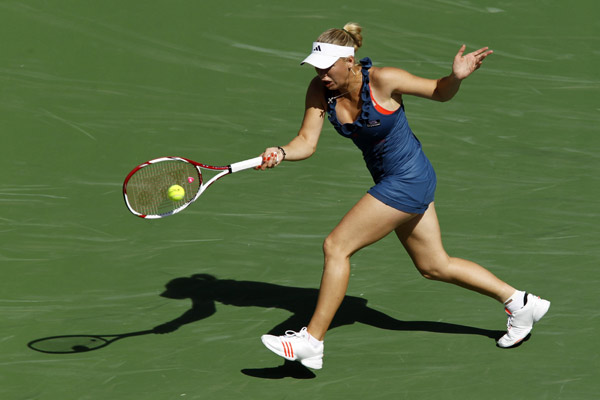 Caroline Wozniacki of Denmark returns a shot against Maria Jose Martinez Sanchez of Spain during their match at the Indian Wells WTA tennis tournament in Indian Wells, California, March 14, 2011. (Xinhua/Reuters Photo) 