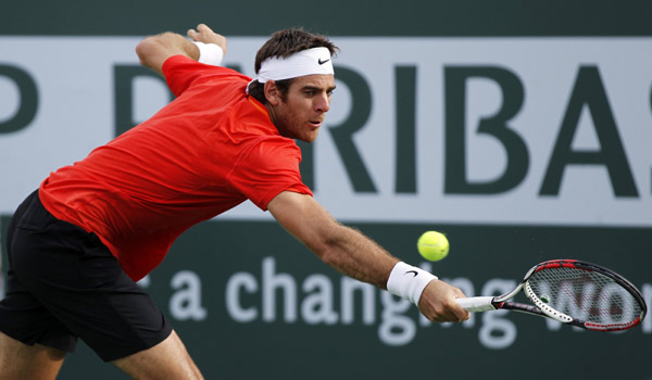 Juan Martin Del Potro of Argentina returns a shot against Alexandr Dolgopolov of Ukraine during their match at the Indian Wells ATP tennis tournament in Indian Wells, California March 14, 2011.(Xinhua/Reuters Photo) 