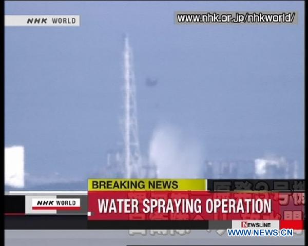 This still image taken from news program by NHK on March 17, 2011 shows a helicopter spray water on the reactors of Japan's troubled Fukushima No. 1 nuclear power station. Helicopters were sent by Japan's self-defense force on Friday to cool down the reactors of Fukushima No. 1 nuclear power station. [Xinhua/NHK] 