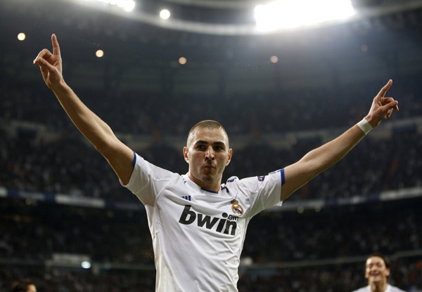 Real Madrid's Karim Benzema celebrates after scoring against Olympique Lyon during their second leg round of 16 Champions League soccer match at Santiago Bernabeu stadium in Madrid March 16, 2011. (Xinhua/Reuters Photo) 