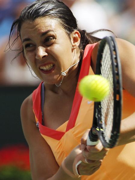 Marion Bartoli of France returns a shot to Ana Ivanovic of Serbia during their match at the Indian Wells WTA tennis tournament in Indian Wells, California March 16, 2011. (Xinhua/Reuters Photo)