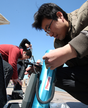 Staff workers measure the radiation level and monitor the environment in the coastal area of Yantai, Shandong Province, on March 16. 