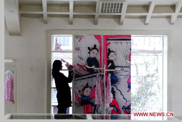 A student views the artworks at the Sichuan needlework museum in Chengdu, capital of southwest China's Sichuan Province, March 16, 2011. 