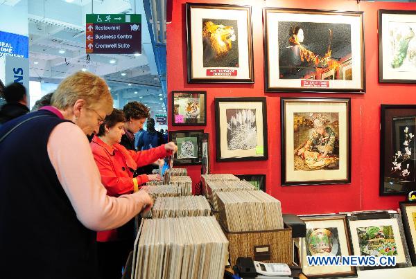 Visitors select traditional Chinese Suzhou Embroidery works at the Ideal Home Show held at Earls Court Exhibition Centre in London, Britain, March 16, 2011. 