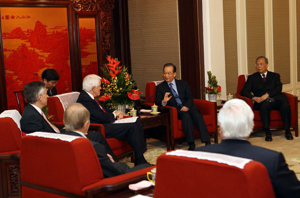 Chinese Premier Wen Jiabao talks to delegates participating the first round of dialogues between China-U.S. business leaders and former government officials in Beijing on March 17, 2011. [Xinhua]