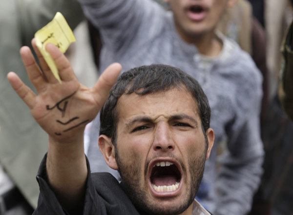 An anti-government protester shouts slogans during a rally demanding the ouster of Yemen&apos;s President Ali Abdullah Saleh in Sanaa March 18, 2011.