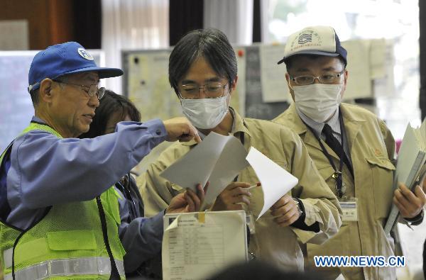 Experts work at the disaster countermeasures unit in Fukushima, March 19, 2011. Nuclear experts, emergency staff and firefighters gathered here to deal with the situation of Japan&apos;s Fukushima No.1 nuclear power plant. 