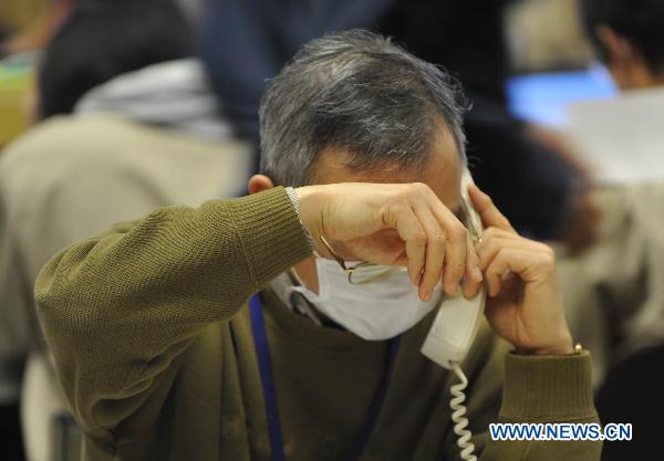 An expert speaks on the phone at the disaster countermeasures unit in Fukushima, March 19, 2011. Nuclear experts, emergency staff and firefighters gathered here to deal with the situation of Japan&apos;s Fukushima No.1 nuclear power plant.