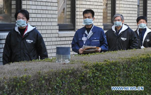 Experts pass by the entrance to the disaster countermeasures unit in Fukushima, March 19, 2011. Nuclear experts, emergency staff and firefighters gathered here to deal with the situation of Japan&apos;s Fukushima No.1 nuclear power plant. 