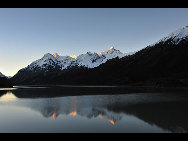 Ranwu Lake is called 'the Tibetan Switzerland.' The lake is set more than 3,800 meters above sea level and has an area of 22,000 square km. The seasons dictate the water's color, which ranges from aquamarine to turquoise. When the sun rises, the lake looks like a mirror reflecting snow-capped mountains, white clouds and the surrounding forest.[KingzenQue/forums.nphoto.net]