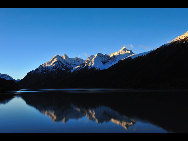 Ranwu Lake is called 'the Tibetan Switzerland.' The lake is set more than 3,800 meters above sea level and has an area of 22,000 square km. The seasons dictate the water's color, which ranges from aquamarine to turquoise. When the sun rises, the lake looks like a mirror reflecting snow-capped mountains, white clouds and the surrounding forest.[KingzenQue/forums.nphoto.net]