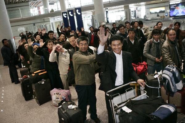 Chinese nationals arrive at Beijing Capital International Airport in Beijing, China, Feb. 27, 2011. Over 320 Chinese nationals evacuated from Libya to the Greek island of Crete flied back home on Sunday. [Xinhua]