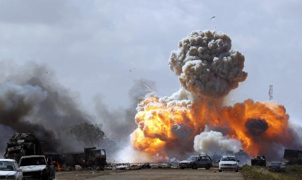 Vehicles belonging to forces loyal to Libyan leader Muammar Gaddafi explode after an air strike by coalition forces, along a road between Benghazi and Ajdabiyah March 20, 2011.