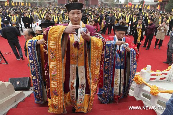 Taoist priests pose a ceremonial gesture during a memorial ceremony for Laozi (or Lao-tzu, Lao-tse 604-531 BC) 2,582 birth anniversary in Tianjing Palace (or Heavenly Peace Palace), Woyang County of east China's Anhui Province, March 19, 2011. 