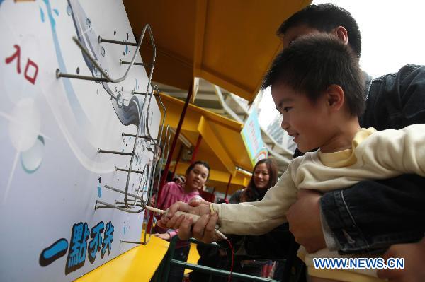 A boy plays a game during the 2011 World Water Day festival in Macao, south China, March 20, 2011. The festival was held here Sunday to greet the upcoming World Water Day that falls on March 22. 