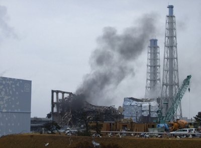 In Japan, nuclear power plant operators evacuated workers from the quake-hit Fukushima nuclear complex on Monday, after seeing gray smoke rising from one reactor.