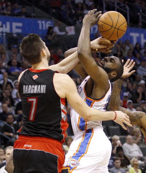 Oklahoma City Thunder's James Harden (R) is fouled by Toronto Raptors center Andrea Bargnani (L) in Oklahoma City, Sunday, March 20, 2011. Toronto Raptorsbeated Oklahoma City Thunder 95:93. (Xinhua/Reuters Photo) 