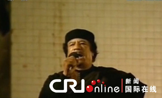 The TV footage showed Gadhafi making a short live address to his supporters late Tuesday in a week at a balcony near the Libyan capital of Tripolibefore a crowd of supporters at his residence compound.