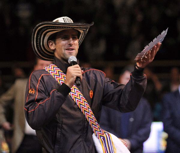 Novak Djokovic of Serbia speaks to the public wearing a typical Colombian 'Vueltiao' hat after an exhibition tennis match against Rafael Nadal of Spain March 21, 2011.(Xinhua/Reuters Photo)