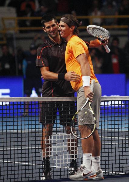 Rafael Nadal, of Spain, right, and Novak Djokovic, of Serbia, greet each other after an exhibition match in Bogota, Colombia, Monday, March 21, 2011. (Xinhua/Reuters Photo)