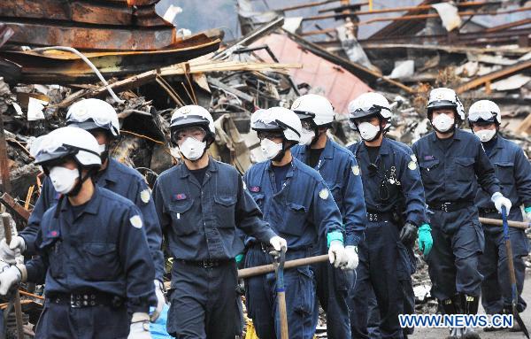 Rescue workers search in building debris in Otsuchi of Iwate Prefecture, Japan, March 21, 2011. Otsuchi is one of the worst devastated area in the earthquake and tsunami. 