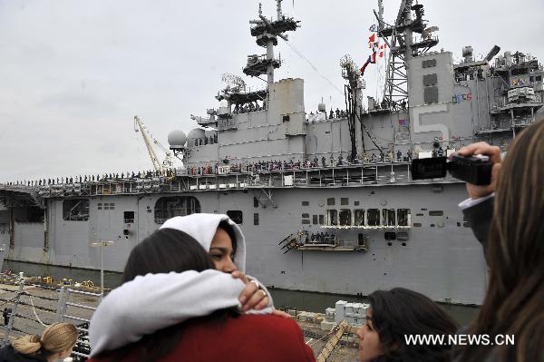 Family members see off the amphibious assault ship USS Bataan (LHD 5) at the Norfolk Naval Base in Virginia, the United States, March 23, 2011. The U.S. Navy on Wednesday dispatched the amphibious assault ship USS Bataan, the amphibious transport dock ship USS Mesa Verde and the dock landing ship USS Whidbey Island to the Mediterranean to join the military mission in Libya. [Zhang Jun/Xinhua]