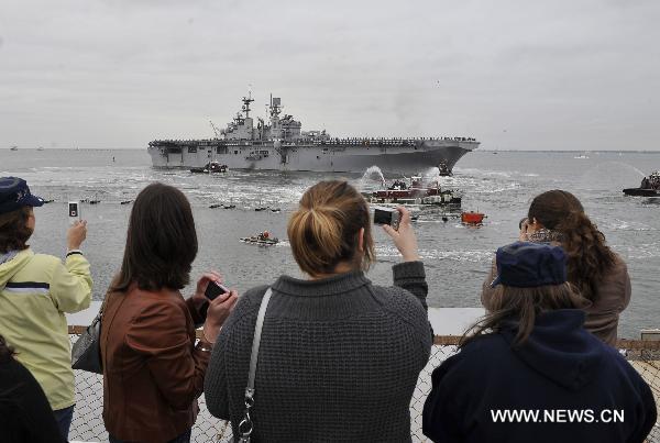 Family members see off the amphibious assault ship USS Bataan (LHD 5) at the Norfolk Naval Base in Virginia, the United States, March 23, 2011. The U.S. Navy on Wednesday dispatched the amphibious assault ship USS Bataan, the amphibious transport dock ship USS Mesa Verde and the dock landing ship USS Whidbey Island to the Mediterranean to join the military mission in Libya. [Zhang Jun/Xinhua]