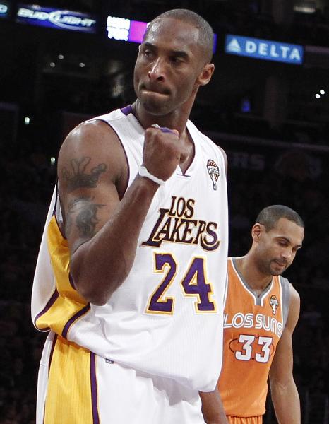 Los Angeles Lakers' Kobe Bryant celebrates after scoring as he walks past Phoenix Suns' Grant Hill during the first half of their NBA game in Los Angeles, California March 22, 2011. (Xinhua/Reuters Photo)