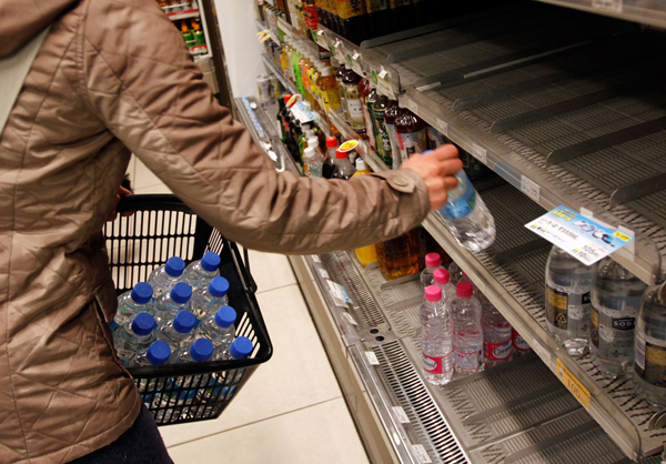 People rush to purchase imported mineral water in a supermarket in Tokyo after radioactivity was detected in tap water, some vegetables and milk, with radioactive iodine present in concentrations above Japanese regulatory limits.