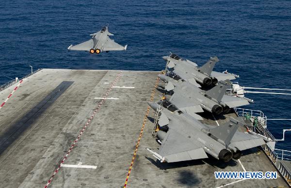 Handout photo released by ECPAD (The French Defence communication and audiovisual production agency) on March 24, 2011 shows a Rafale fighter jet takes off from the Charles de Gaulle aircraft carrier on March 23, 2011. [Xinhua/ECPAD]