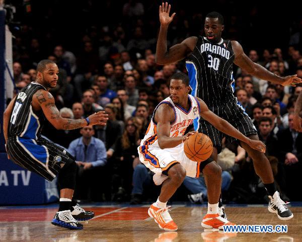 Toney Douglas(C) of New York Knicks dribbles during their NBA basketball game against Orlando Magic in New York, the United States, March 23, 2011. New York Knicks lost by 99-111. (Xinhua/Shen Hong)