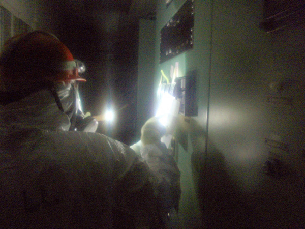 A staff worker from the Tokyo Electric Power Company checks equipment and collects data in the control room of the Fukushima Daiichi nuclear power plant on March 23, 2011.