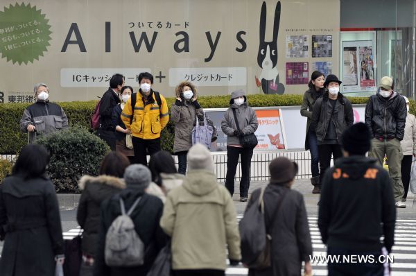 People cross the street in Fukushima City, Japan, March 25, 2011. The city has been witnessing a change of people&apos;s life since the nuclear crisis broke out at the the crippled Fukushima Daiichi nuclear power plant after the earthquake. [Huang Xiaoyong/Xinhua]