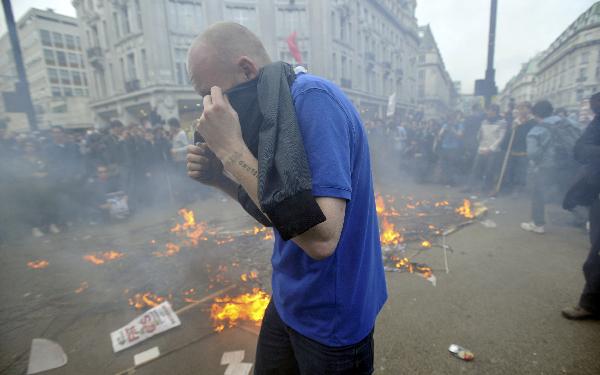 A fire burns in Oxford Circus, during a protest organised by the Trades Union Congress (TUC), called 'The March for the Alternative,' in central London March 26, 2011. Tens of thousands of Britons protested against the coalition government's austerity measures on Saturday in the biggest demonstration in the capital since the Iraq War in 2003. (Xinhua/Reuters Photo)