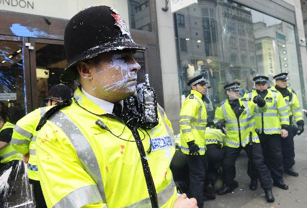 A policeman is splashed with paint in Oxford Street during a protest organised by the Trades Union Congress (TUC), called 'The March for the Alternative,' in central London March 26, 2011. (Xinhua/AFP Photo)