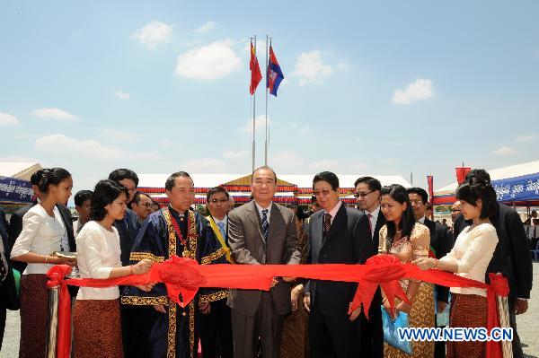 Chinese Ambassador to Cambodia Pan Guangxue (C, front) cuts the ribbon to inaugurate a new teaching building of the Confucius Institute of the Royal Academy of Cambodia, in Phnom Penh, Cambodia, March 28, 2011.