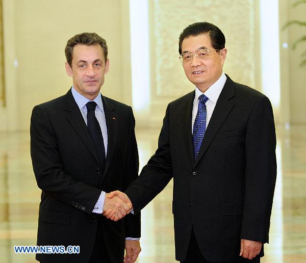 Chinese President Hu Jintao (R) meets with French President Nicolas Sarkozy in Beijing, capital of China, March 30, 2011. Sarkozy arrived in Beijing Wednesday afternoon to attend a seminar on the international monetary system. [Li Tao/Xinhua]