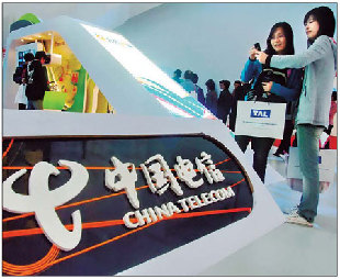Visitors take photos in front of the China Telecommunications Corporation booth at a telecom exhibition in Shanghai this year. The number of subscribers using the company&apos;s mobile services has risen to more than 100 million. [China Daily]