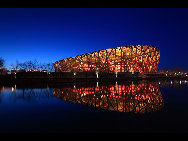 The National Stadium, as the main track and field stadium for the 2008 Olympics Games, is dubbed the 'bird's nest' because of its innovative grid formation.The stadium was begun in March 2004 and finished in March 2008. It was built with 36 kilometers of unwrapped steel, with a combined weight of 45,000 tonnes. Covering over 258,000 square meters, the stadium has at least 100,000 seats. [manqingwangye/jingnei.net] 
