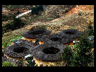 Photo shows the Tianluokeng Tulou, earth buildings in Chinese, in Nanjing County, southeast China's Fujian Province. Built on a base of stone, the thick walls of Tulou were packed with dirt and fortified with wood or bamboo internally. The architectural arts of the Fujian Tulou can be traced back nearly 1,000 years, and their design incorporates the tradition of fengshui (favorable siting within the environment). [老人河  /forums.nphoto.net]