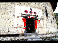 Photo shows the Tianluokeng Tulou, earth buildings in Chinese, in Nanjing County, southeast China's Fujian Province. Built on a base of stone, the thick walls of Tulou were packed with dirt and fortified with wood or bamboo internally. The architectural arts of the Fujian Tulou can be traced back nearly 1,000 years, and their design incorporates the tradition of fengshui (favorable siting within the environment). [老人河  /forums.nphoto.net]