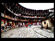 Photo shows the Tianluokeng Tulou, earth buildings in Chinese, in Nanjing County, southeast China's Fujian Province. Built on a base of stone, the thick walls of Tulou were packed with dirt and fortified with wood or bamboo internally. The architectural arts of the Fujian Tulou can be traced back nearly 1,000 years, and their design incorporates the tradition of fengshui (favorable siting within the environment). [老人河  /forums.nphoto.net]