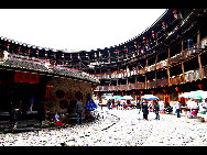 Photo shows the Tianluokeng Tulou, earth buildings in Chinese, in Nanjing County, southeast China's Fujian Province. Built on a base of stone, the thick walls of Tulou were packed with dirt and fortified with wood or bamboo internally. The architectural arts of the Fujian Tulou can be traced back nearly 1,000 years, and their design incorporates the tradition of fengshui (favorable siting within the environment). [老人河  /forums.nphoto.net]